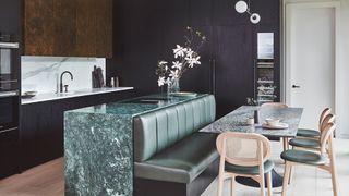 contemporary black kitchen with kitchen island and banquette seating to fit the space: avoiding kitchen design mistakes