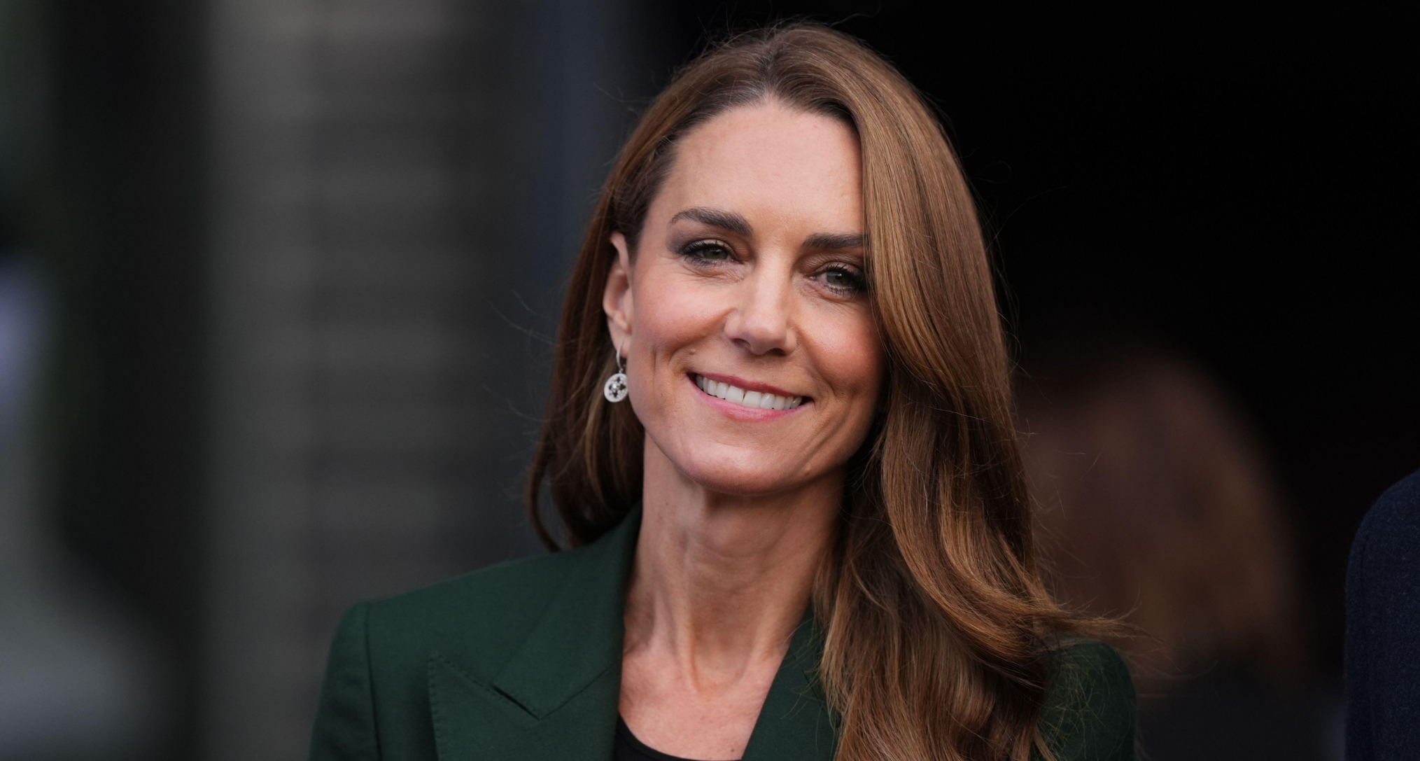 Princess Kate wearing a green blazer and clapping