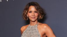 Halle Berry is pictured with short curly hair and wearing a silver beaded dress at the 2025 Kering Women In Motion Awards and Cannes Film Festival Presidential Dinner at the 78th annual Cannes Film Festival at the Place de la Castre on May 18, 2025, in Cannes, France.