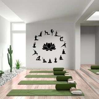 white yoga room with wall decal and green yoga mats