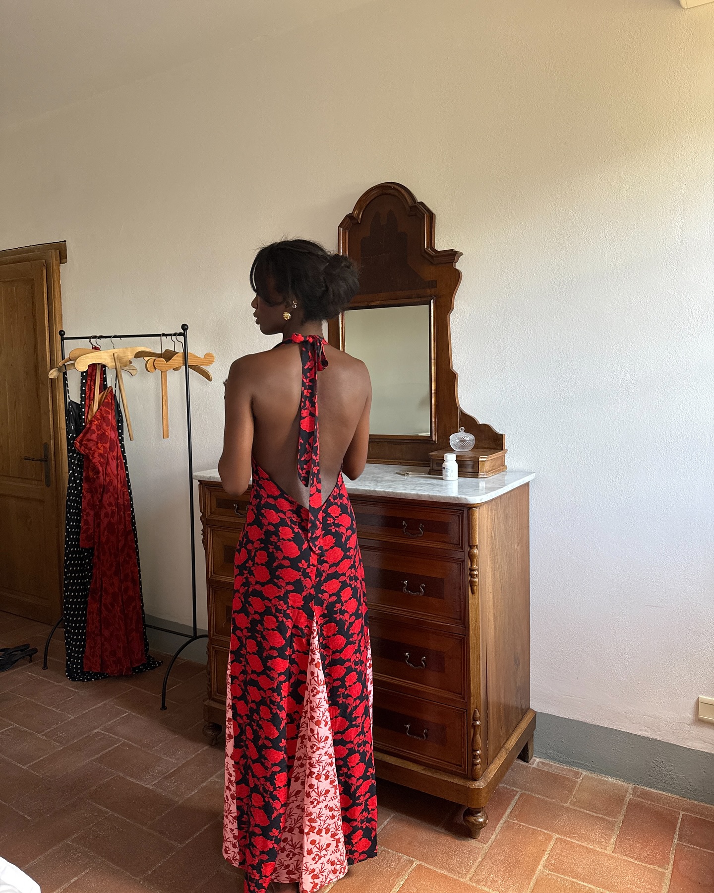 An image of @_livmadeline wearing a black, white and red floral maxi dress.
