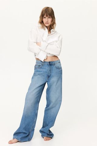 a model wears baggy wide-leg jeans