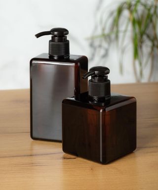 dark glass soap dispensers with black pumps
