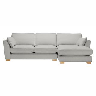 white fabric corner sofa with cushions