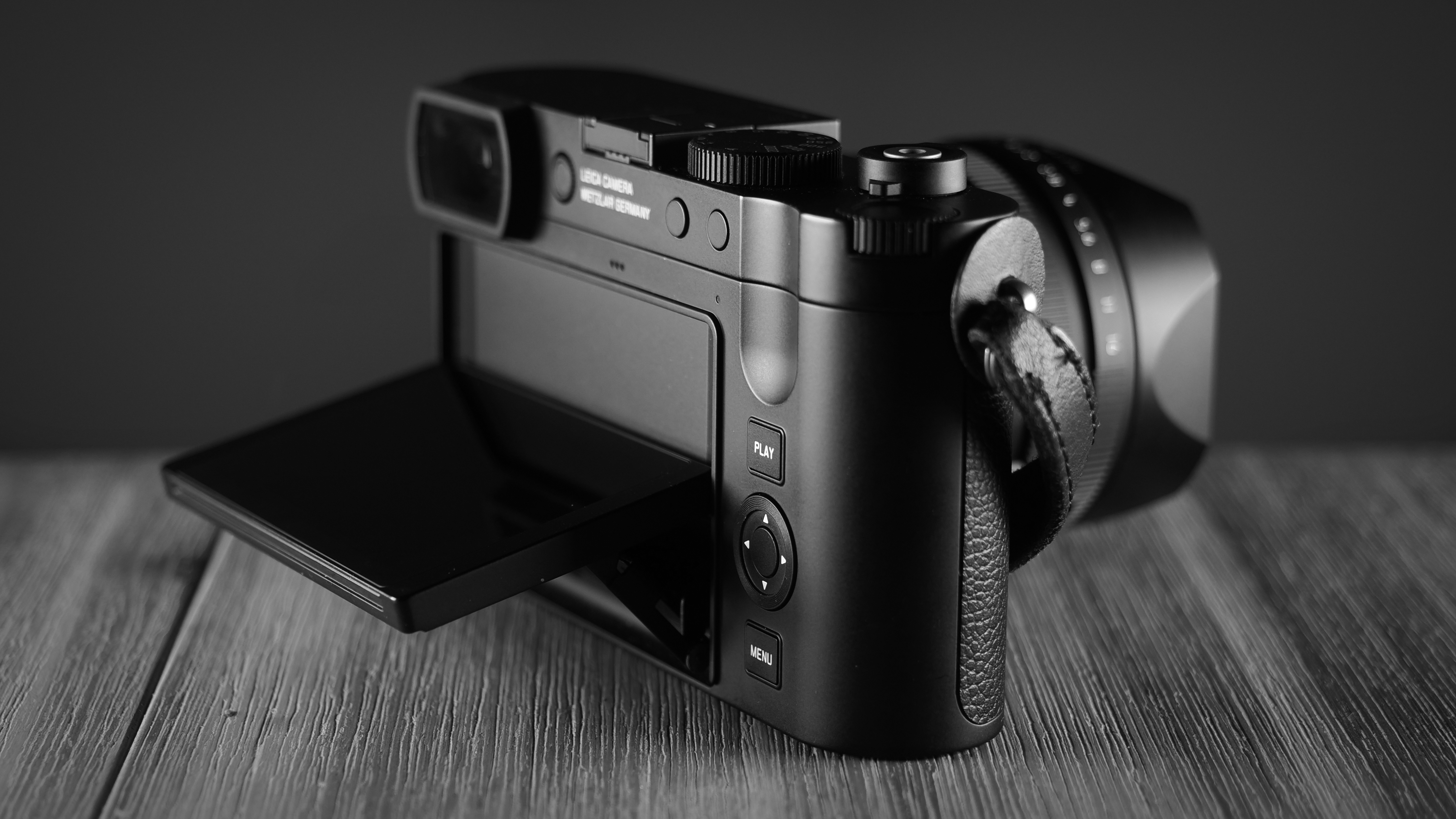 Leica Q3 Monochrom sitting on a wooden surface