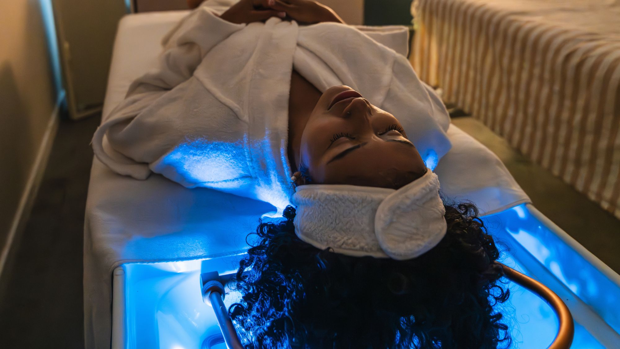 woman lying down at a head spa