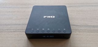 A top-down shot showing the display and buttons on the FiiO DM13 portable CD player.