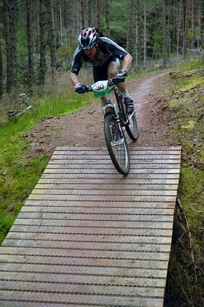 A rider crosses a bridge.