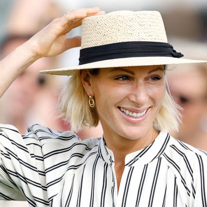 Zara Tindall in a straw hat and striped dress smiling