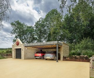 garage and carport in a large driveway with sensor lighting