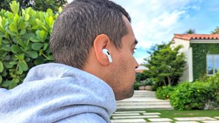 Hero image for best running headphones showing our reviewer running with AirPods Pro 2