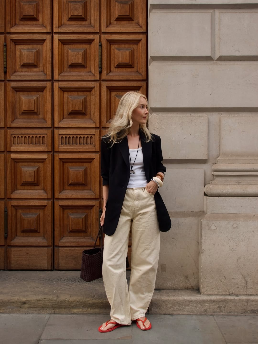 Chloe in red flip-flops and ecru barrel jeans