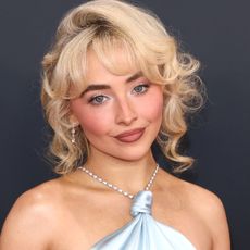 Sabrina Carpenter attends the Grammy Awards in a baby blue satin gown.
