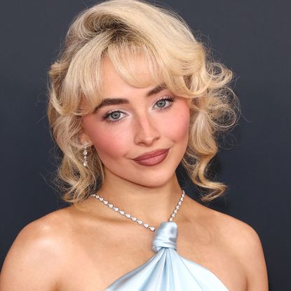 Sabrina Carpenter attends the Grammy Awards in a baby blue satin gown.