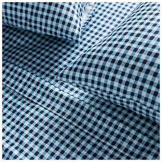 A gingham style organic satin sheet set in blue by Anthropologie