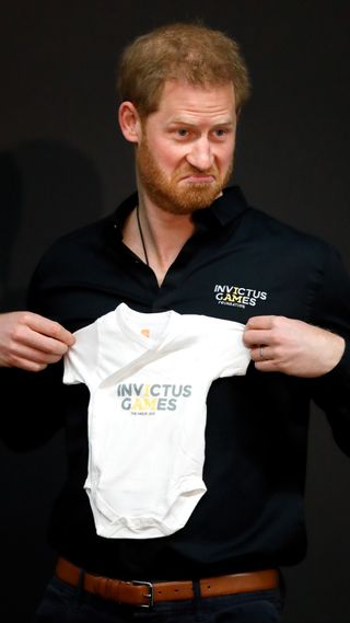 Prince Harry with a babygrow