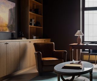 study with dark walls and leather swivel chair