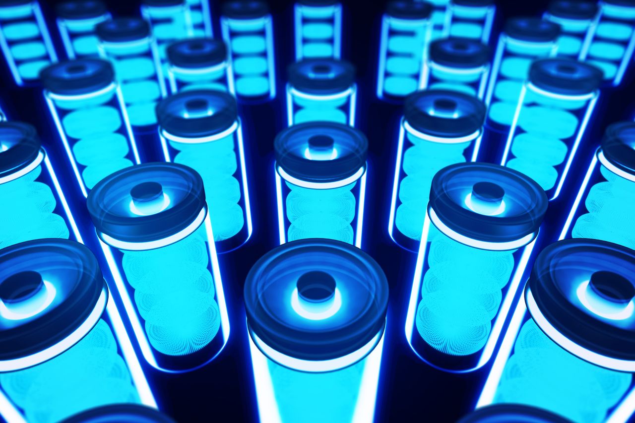 Transparent and blue lithium battery with four cells on a black background