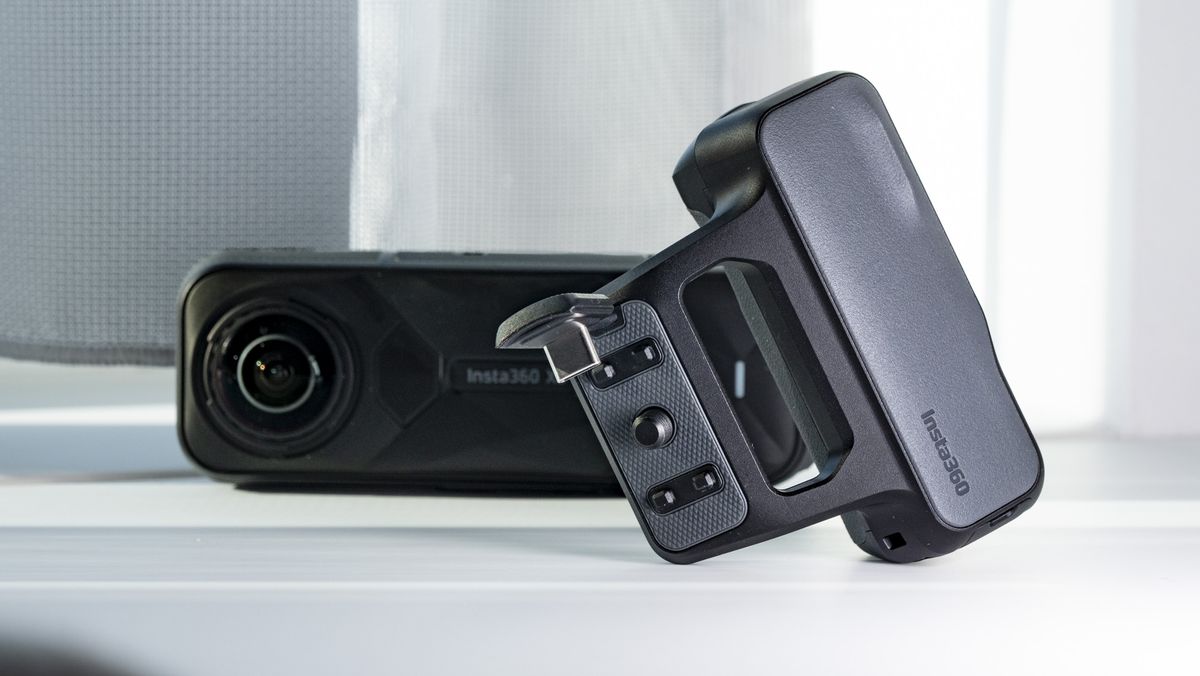 Insta360 X5 Photography Grip alongside to the camera, on a plain white surface