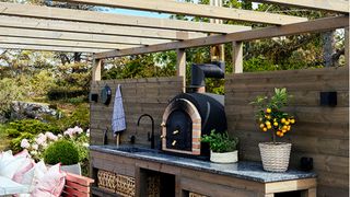 Outdoor kitchen ideas with wooden cabinets and stone sink