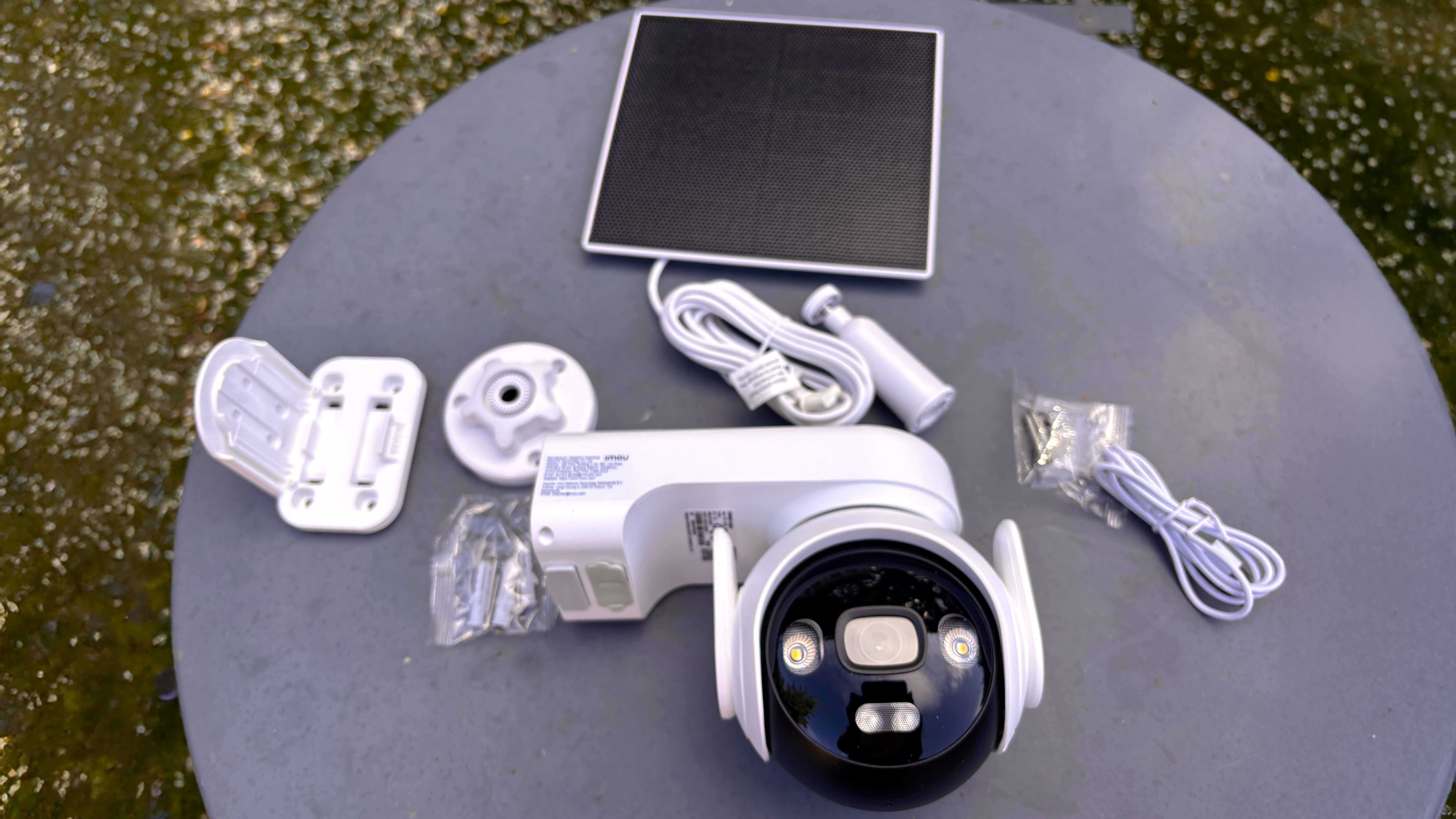 IMOU AOV PT security camera on table with cables and accessories