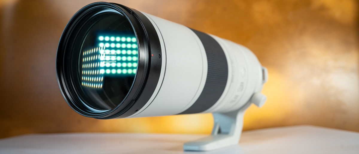 Canon RF 200-800mm f/6.3-9 IS USM lens on a colored surface