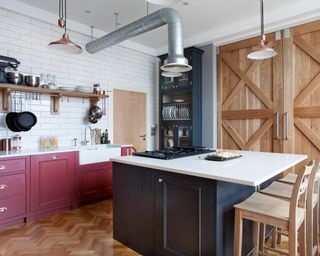 A modern traditional kitchen with paprika red and navy painted cabinetry