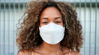 Young woman wearing medical mask. Do masks protect against the Delta variant