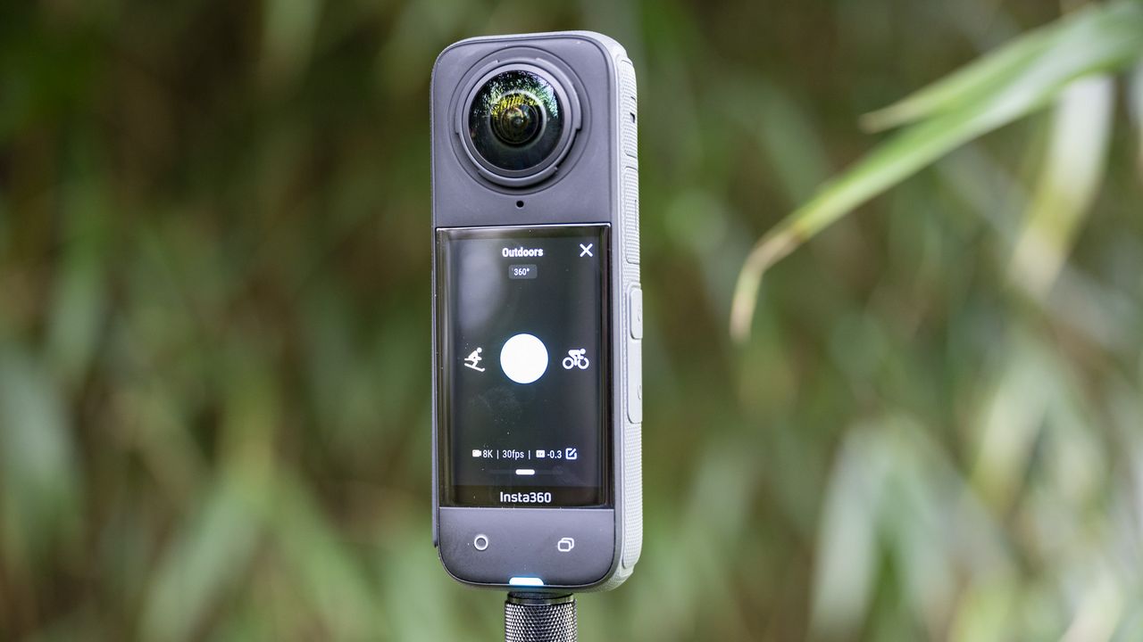 Insta360 X4 360 degree camera outdoors with vibrant grassy background