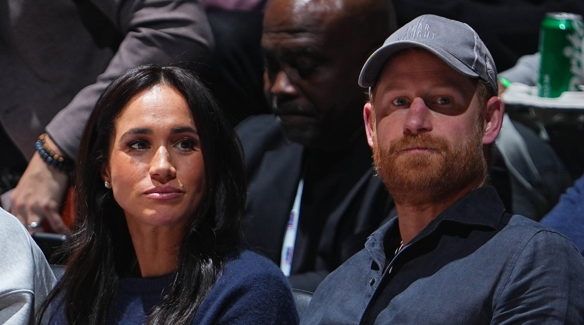 Meghan Markle and Prince Harry match in navy blue outfits while attending an NBA game