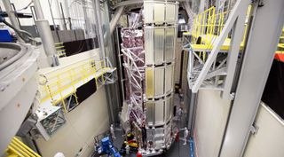 The spacecraft element of NASA's James Webb Space Telescope being prepared for thermal vacuum testing. Problems with the spacecraft played a major factor in overall cost and schedule growth for major NASA programs. 