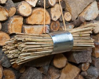 A simple bug hotel design using a tin can and twigs