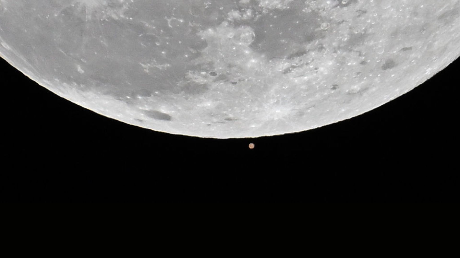 The first full moon of the 2025 called 'Wolf Moon' that seen next to Mars rises over the sky during a lunar occultation of Mars in Charlotte, United States on January 13, 2025.