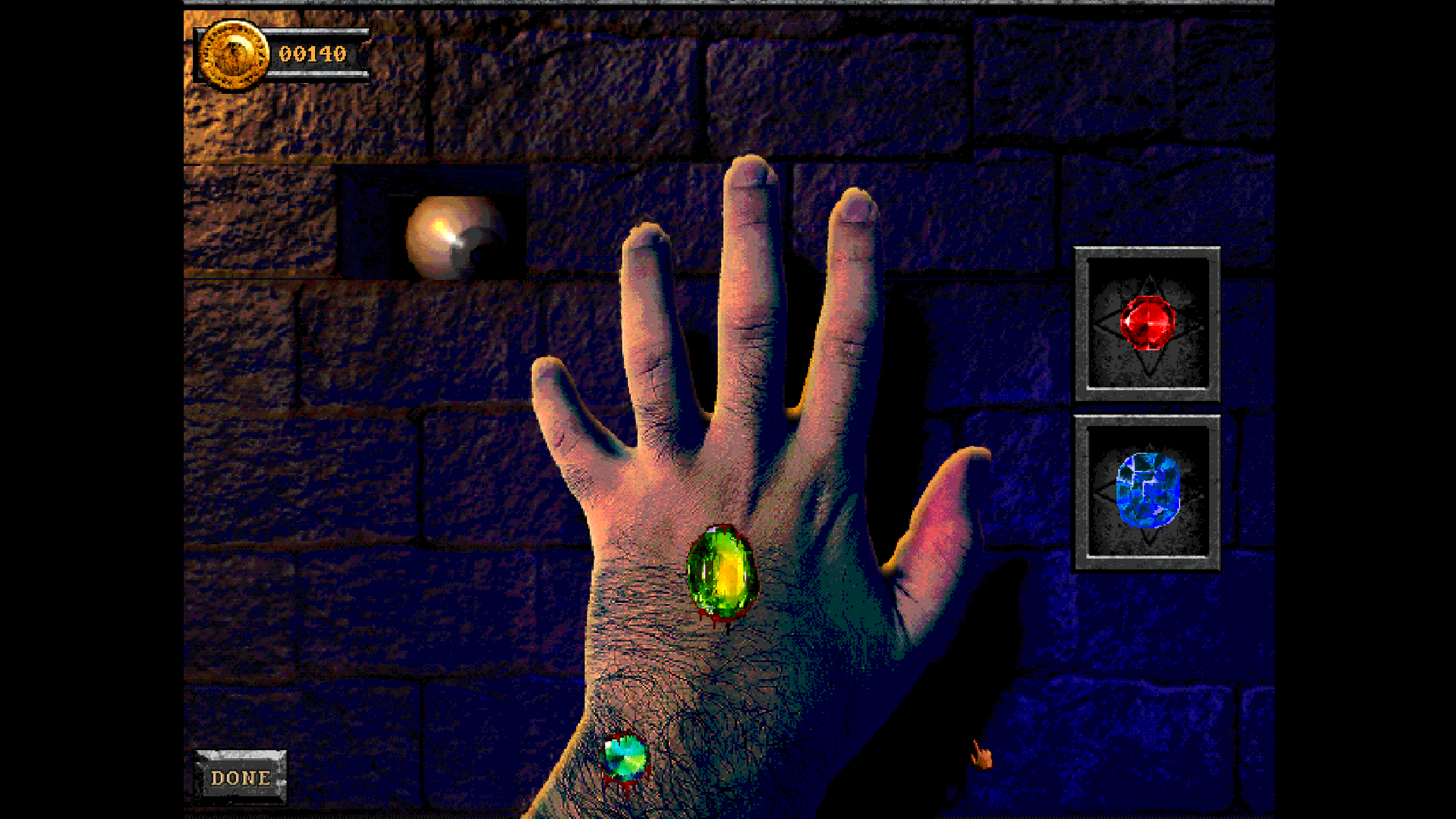 A screenshot of Forbidden Solitaire. A hand rests in the middle of the screen with gems embedded into its flesh.