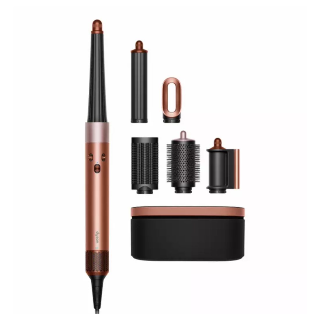 A product shot of the Dyson Airwrap i.d Amber Silk for Straight Wavy, with all its attachments and travel case, on a white background