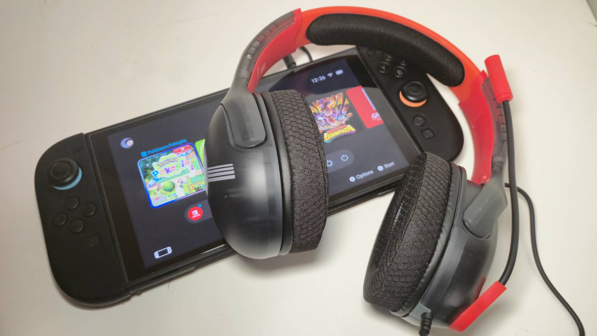 Photo of the Mario Star Airlite Fit wired headset sitting on a Nintendo Switch 2.