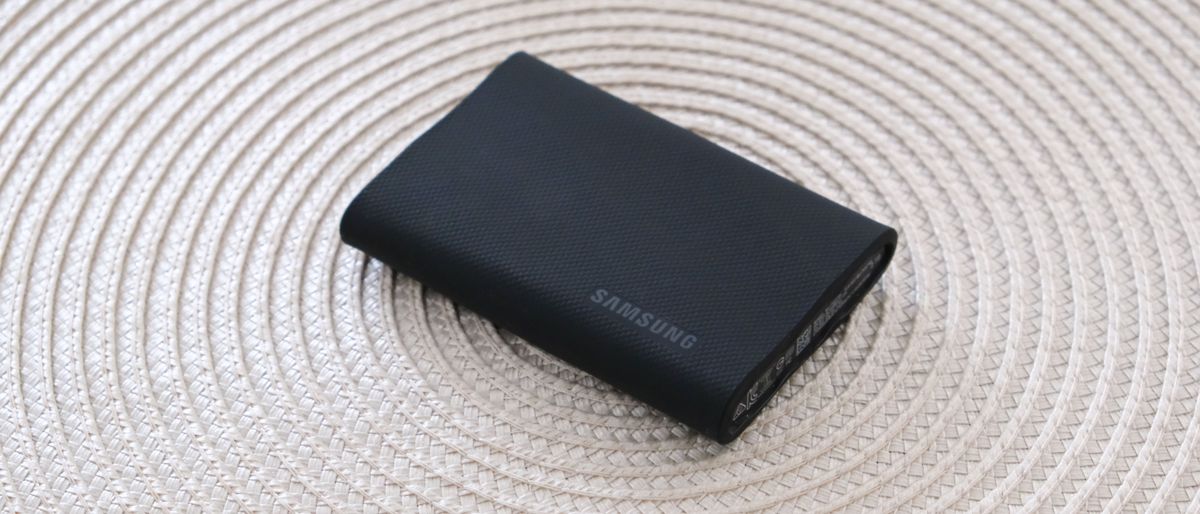 Samsung T9 portable SSD on a white wicker mat