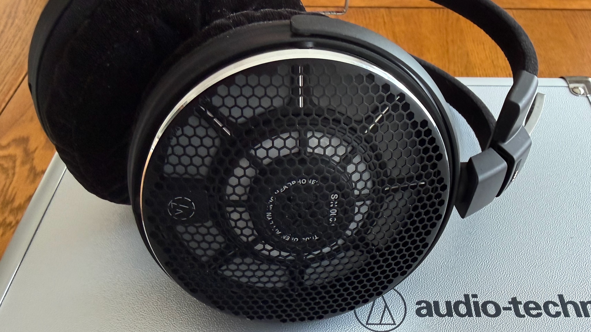Photos of the Audio-Technica ATH-ADX7000 headphones on a wooden table
