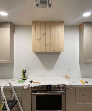 DIYing range hood for farmhouse kitchen with wooden panels