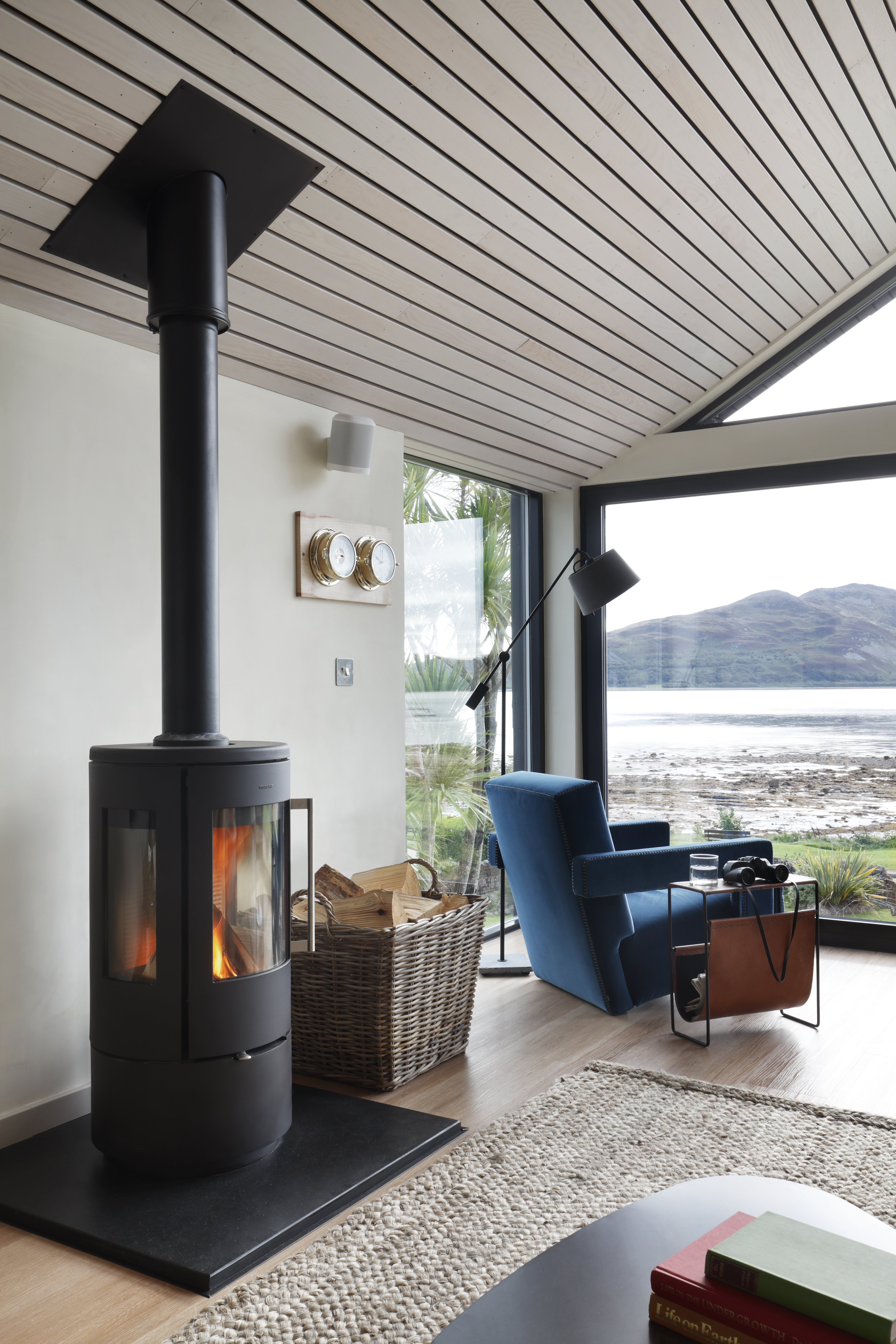 A seating area with architectural windows without curtains or blinds