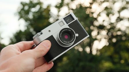 Fujifilm X Half camera held in a hand