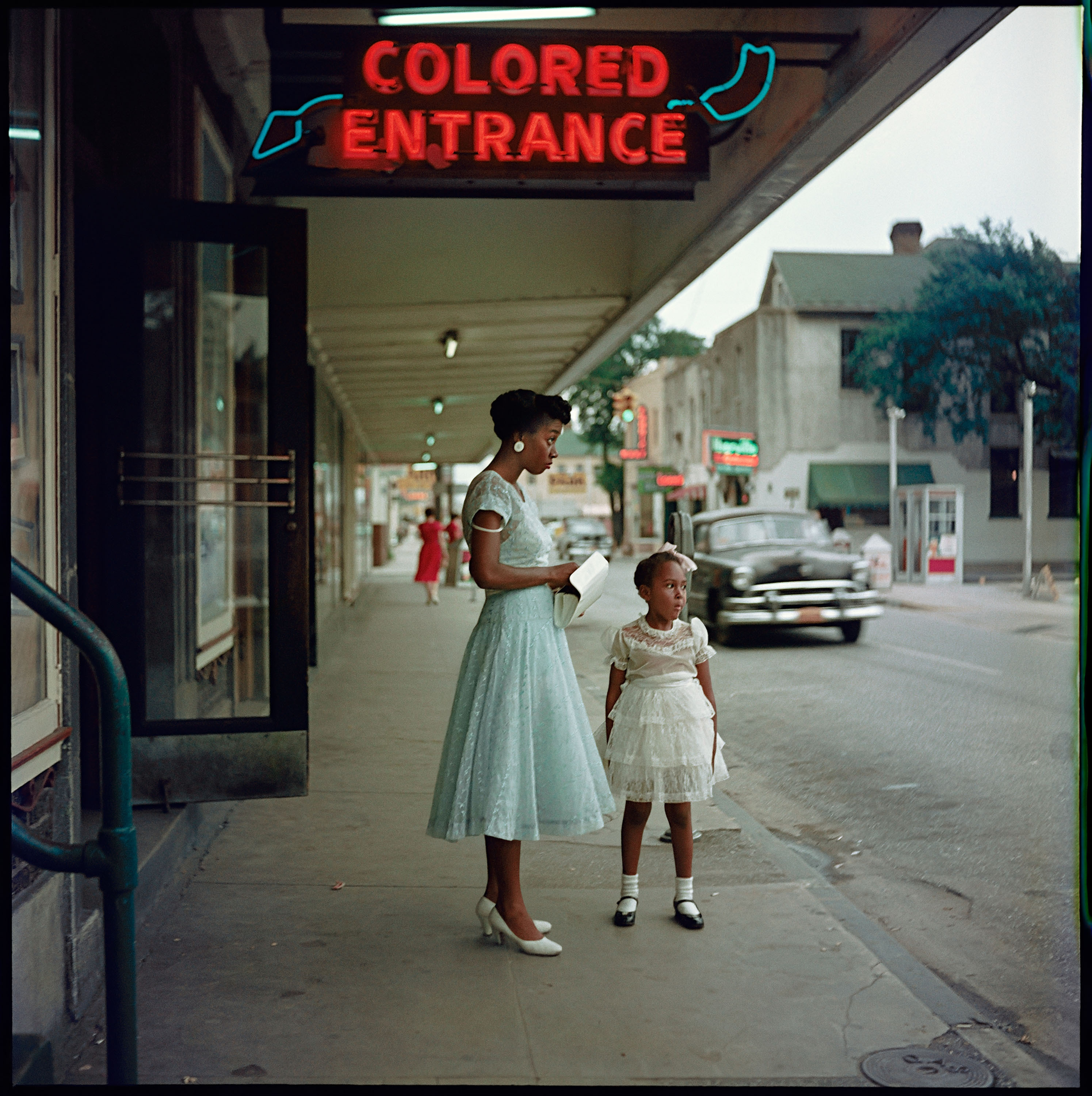girl and woman outside sign saying 'colored entrance'