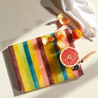 Anthropologie multicolored alabaster serving board with citrus fruit displayed on top