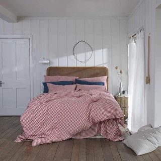 Red gingham bedding on a bed 