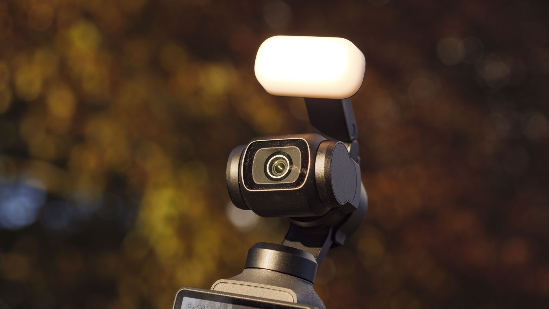 Close up of the DJI Osmo Pocket 4's gimbal camera with fill light attached