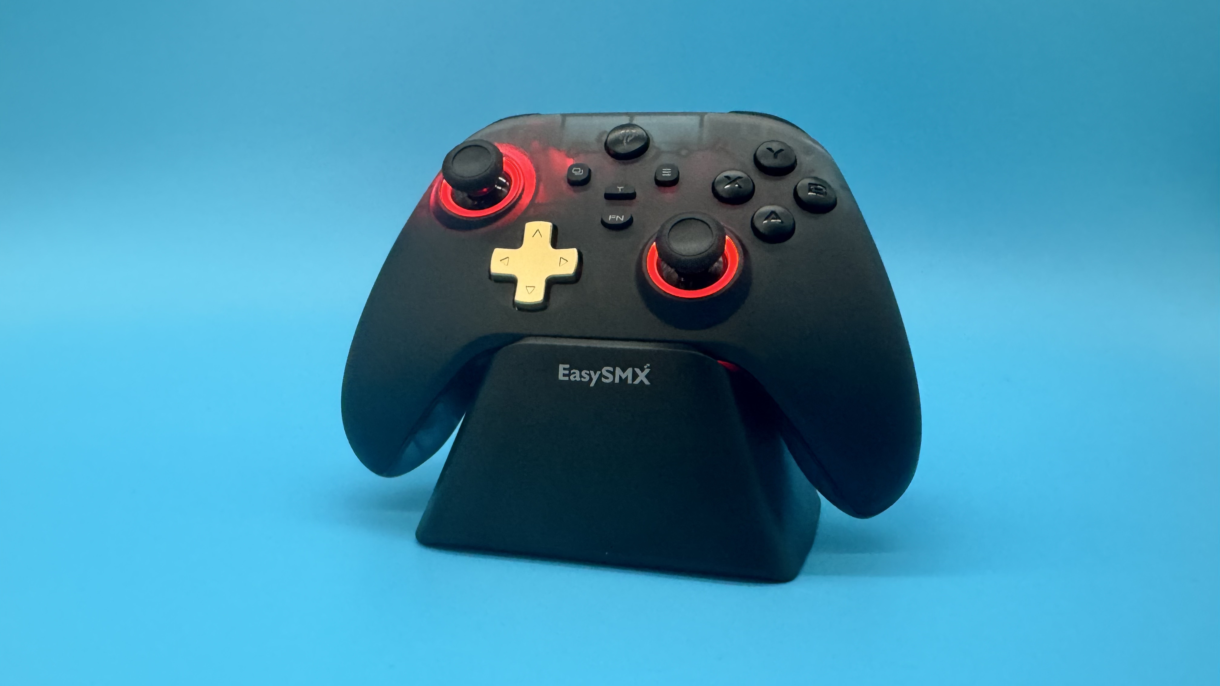 EasySMX D05 black gaming controller on its charging stand with red RGB on, on a blue background