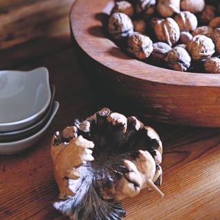 A wooden bowl of walnuts