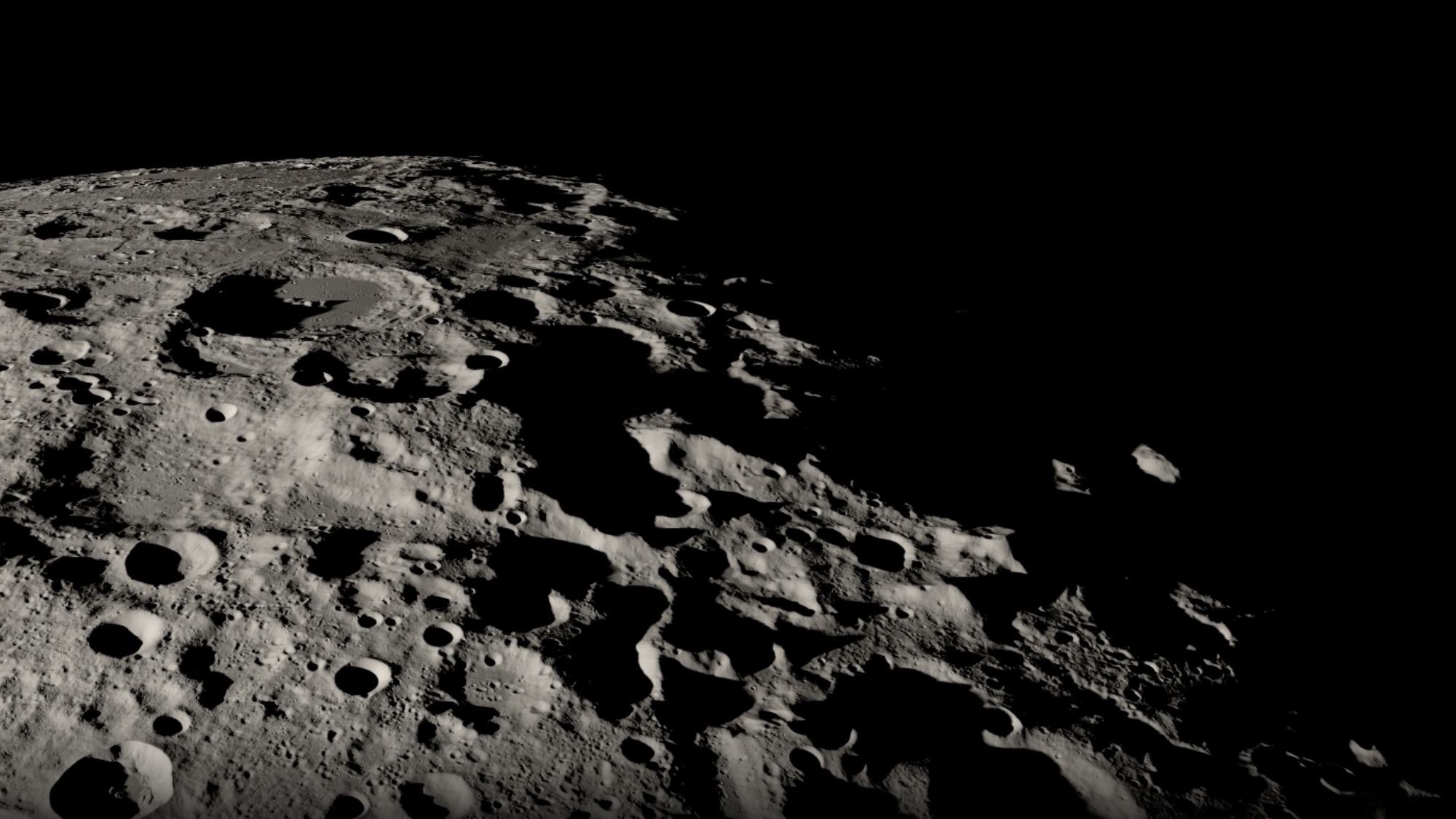 A close up of the moon's black and white, heavily cratered surface.