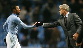 Manchester City's Brazilian Striker Robinho (L) shakes hands with manager Mark Hughes after winning their Premier League football match against Newcastle at the City Of Manchester Stadium in Manchester, north west England on January 28, 2009. AFP PHOTO/Glyn Kirk - FOR EDITORIAL USE ONLY Additional licence required for any commercial/promotional use or use on TV or internet (except identical online version of newspaper) of Premier League/Football League photos. Tel DataCo +44 207 2981656. Do not alter/modify photo. (Photo credit should read GLYN KIRK/AFP via Getty Images)