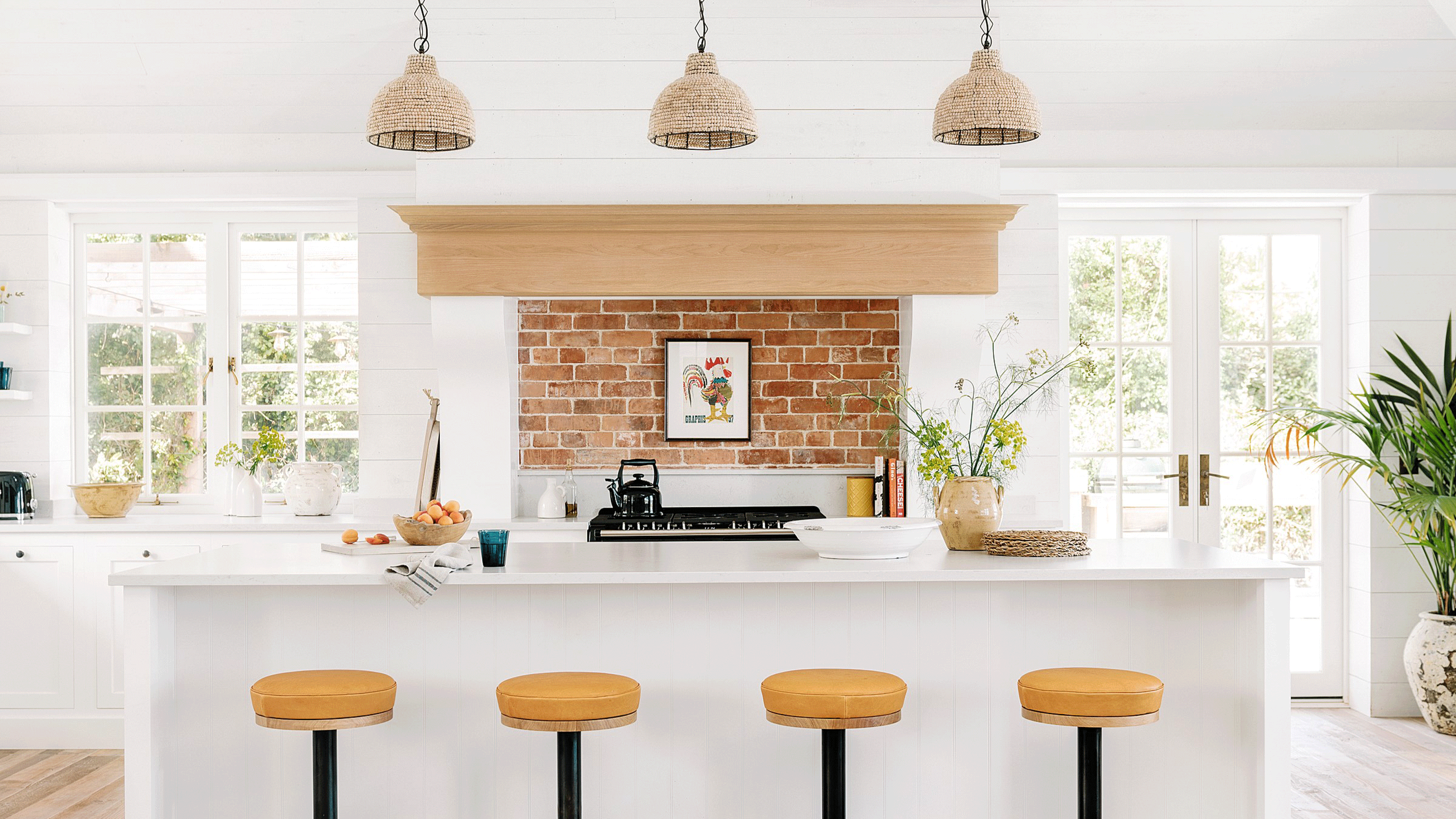 Kitchen with white walls and yellow stools